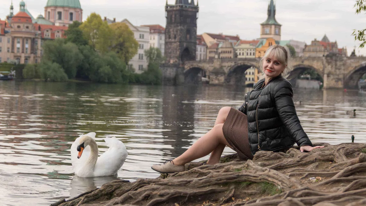 A local photographer posing a family by the Old Town bridge tower during a private photoshoot with a photographer in Prague